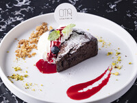Rich chocolate gateau served with seasonal sorbet