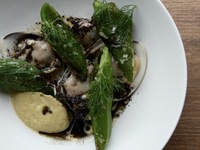 Steamed clams with roasted eggplant hummus and fermented tomato broth.